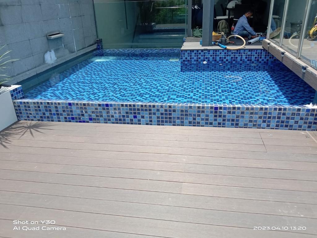 Swimming pool side WPC decking — subframe checks, board setting-out with drainage gaps and finished poolside deck